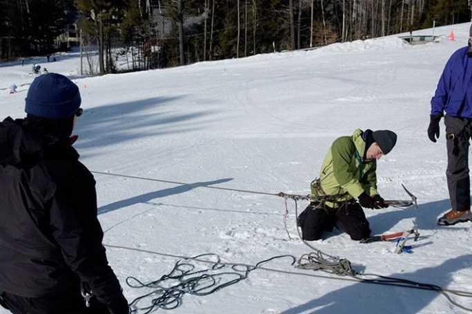 a group of people standing on top of a snow covered slope