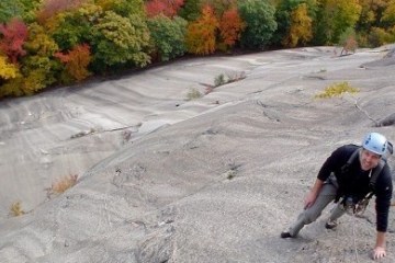 a person climbing up a rocky cliff