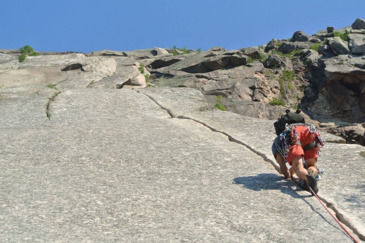 a person climbing up a rocky cliff