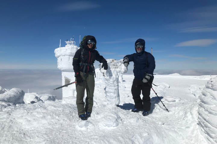 a couple of people that are standing in the snow