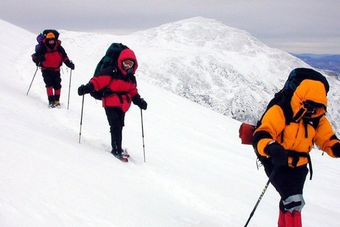 a group of people cross country skiing in the snow