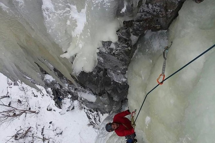 a person climbing up a snow covered slope