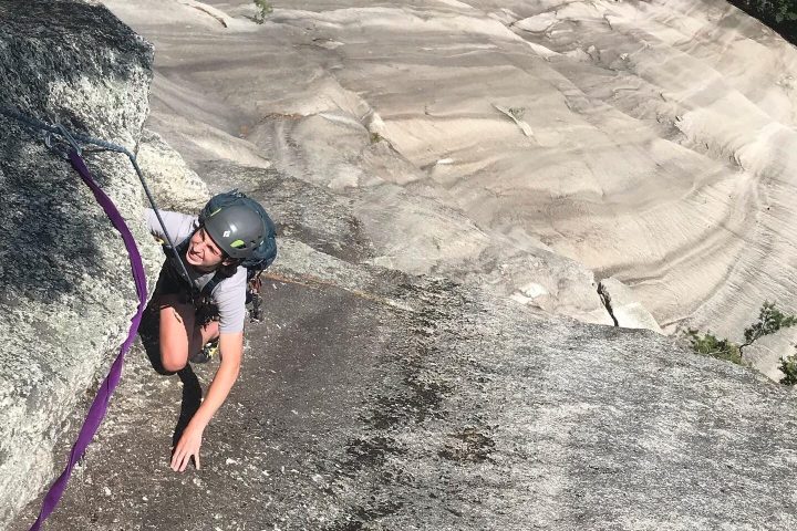 a person climbing up a rocky mountain