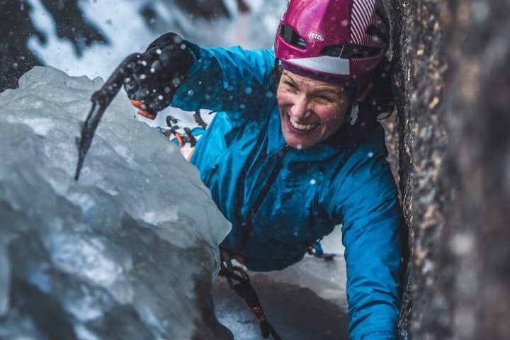 a woman climbing an icy slope