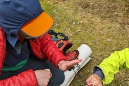 a little boy that is sitting in the grass