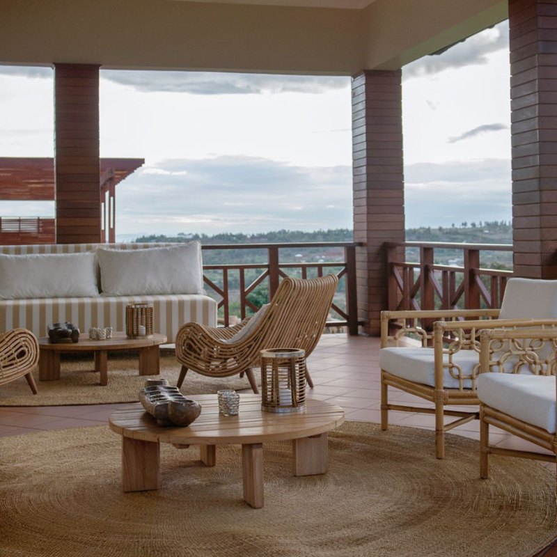 a living room filled with furniture and a large window