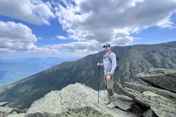 a man standing in front of a mountain